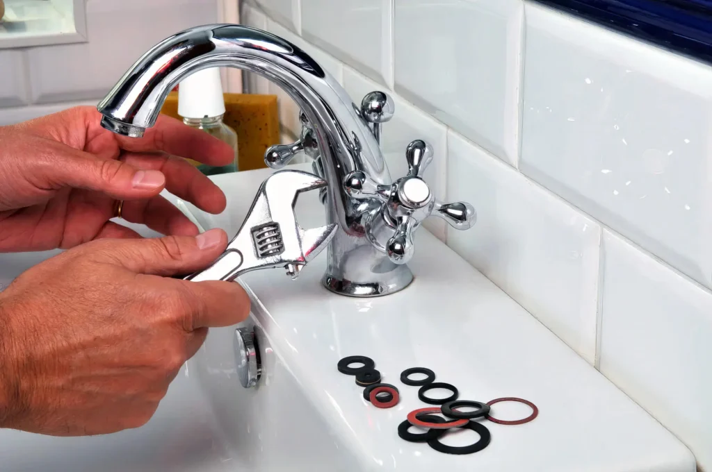 Plumber performing maintenance on a bathroom faucet in Apopka