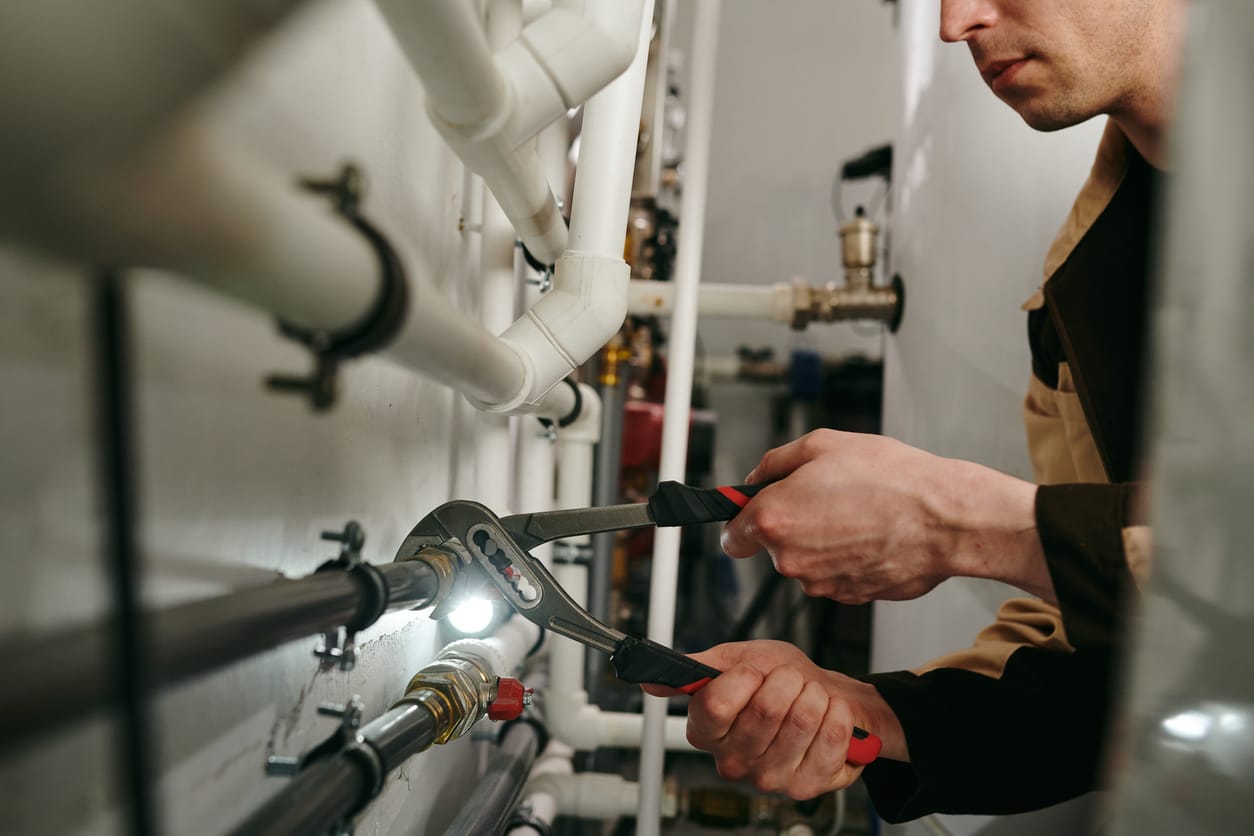 Plumbers maintaining commercial plumbing pipes in Apopka