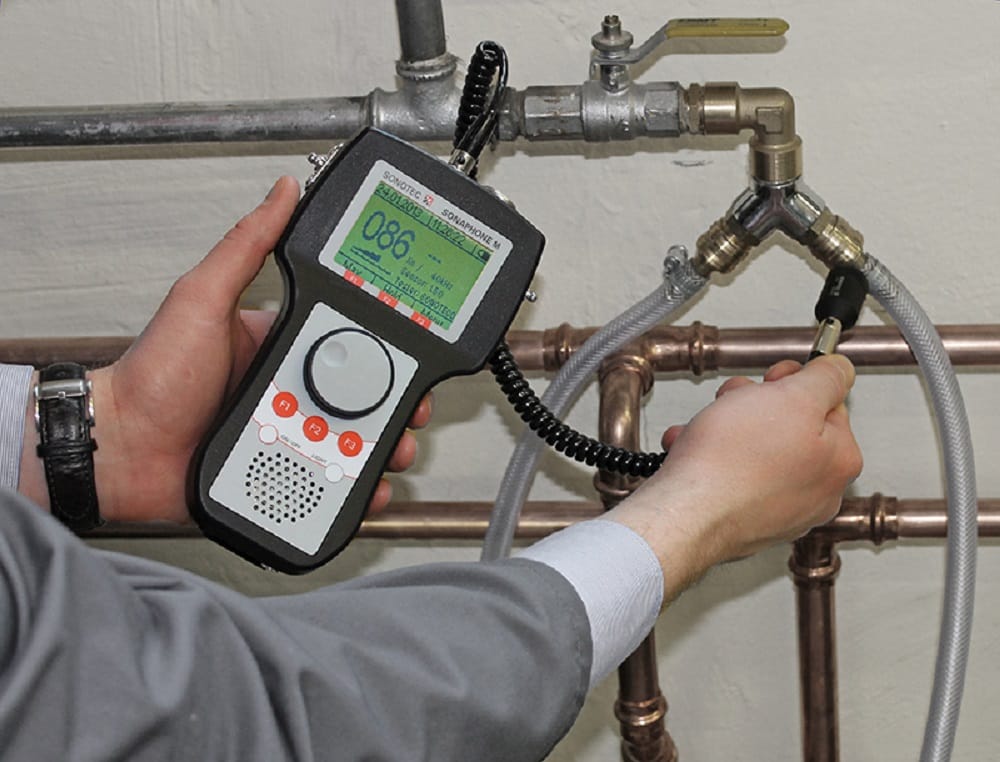 Plumber testing pipes with electronic leak detection equipment in Apopka