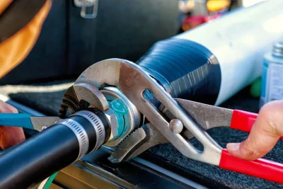 Technician tightening an industrial pipe connection in Apopka