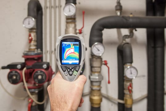 Plumber using a thermal imaging camera to inspect pipes in Apopka