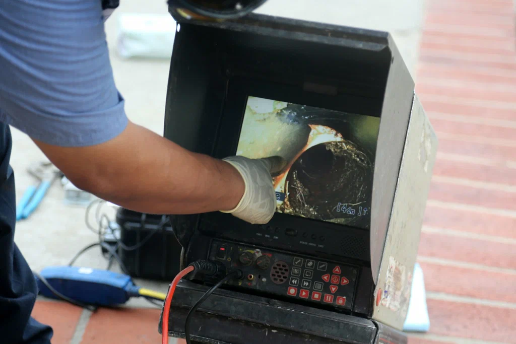 Technician viewing a drain inspection camera in Apopka