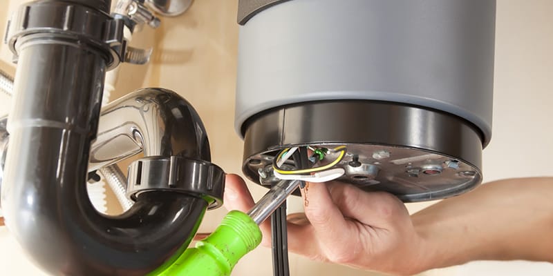 Technician repairing the heating element of a water heater in Apopka