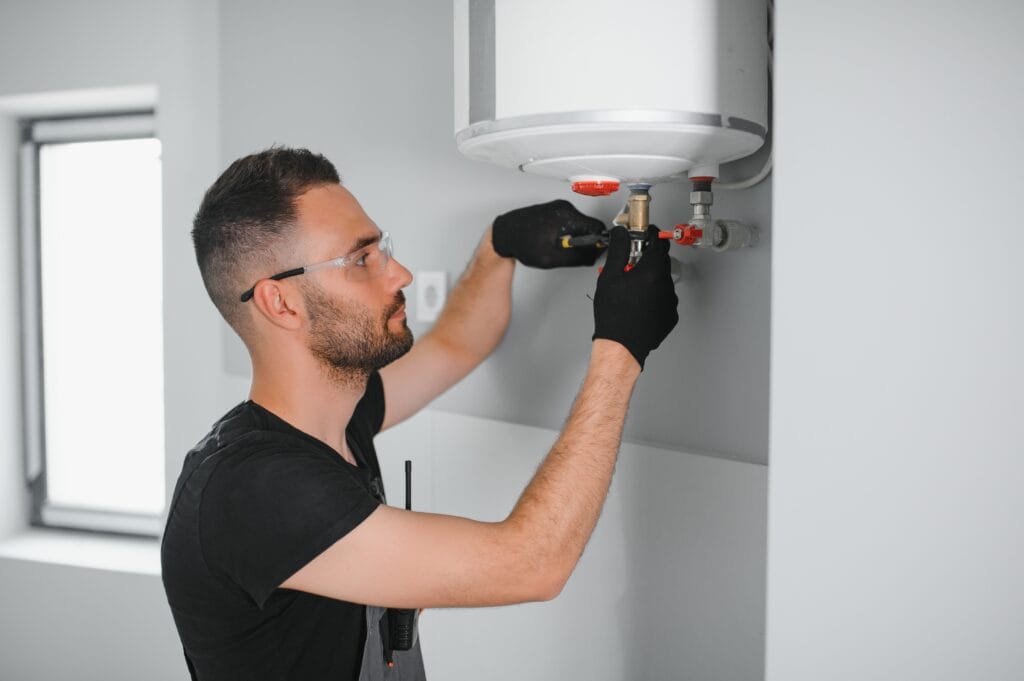 Technician performing water heater maintenance in Apopka