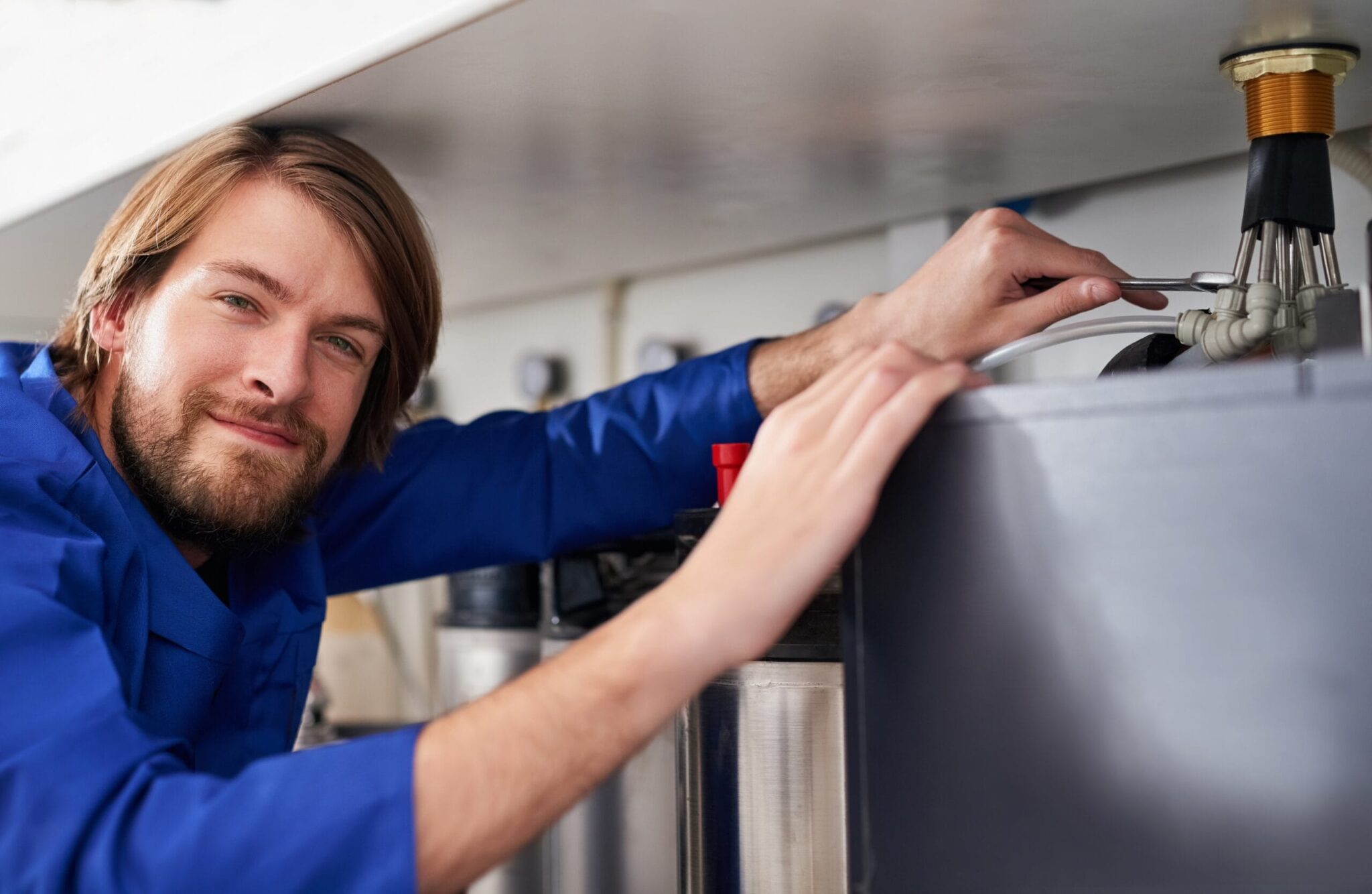 Technician servicing a residential water heater tank in Apopka