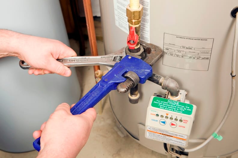Plumber repairing a water heater valve in Apopka